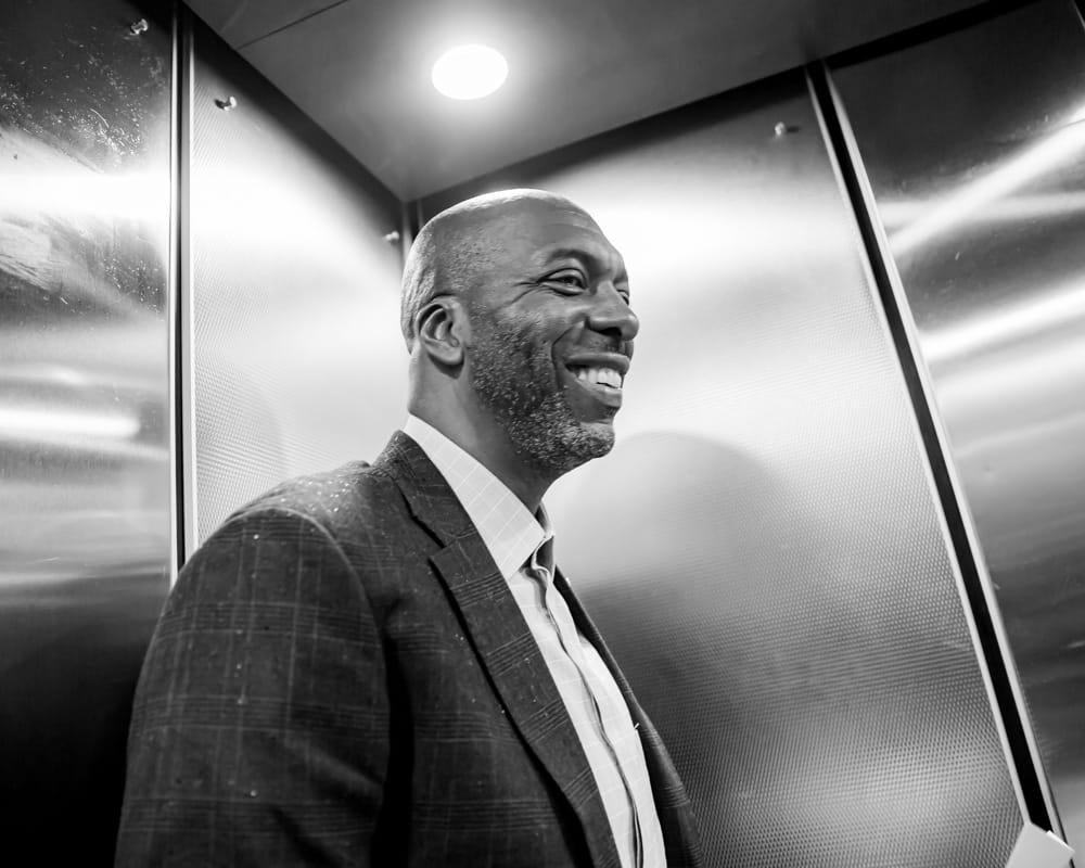 John Salley smiling in the elevator