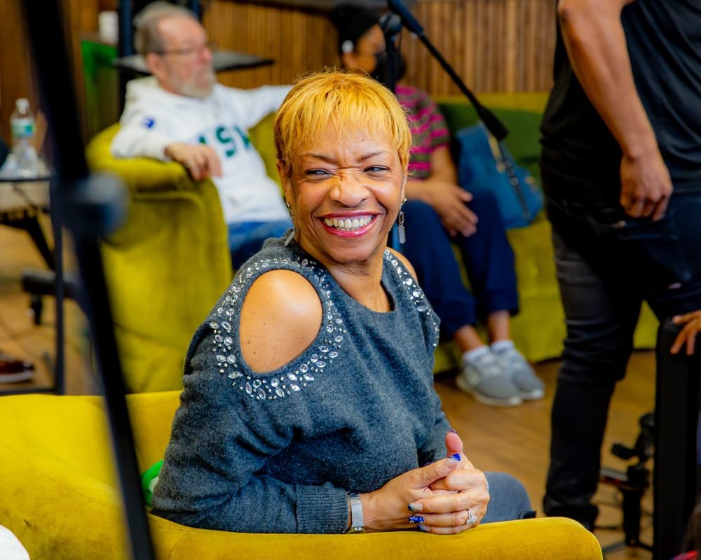 A community leader laughing in the audience