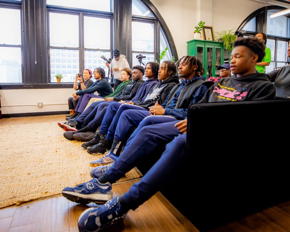 The Bedford Academy High School varsity basketball team seated for the fireside chat