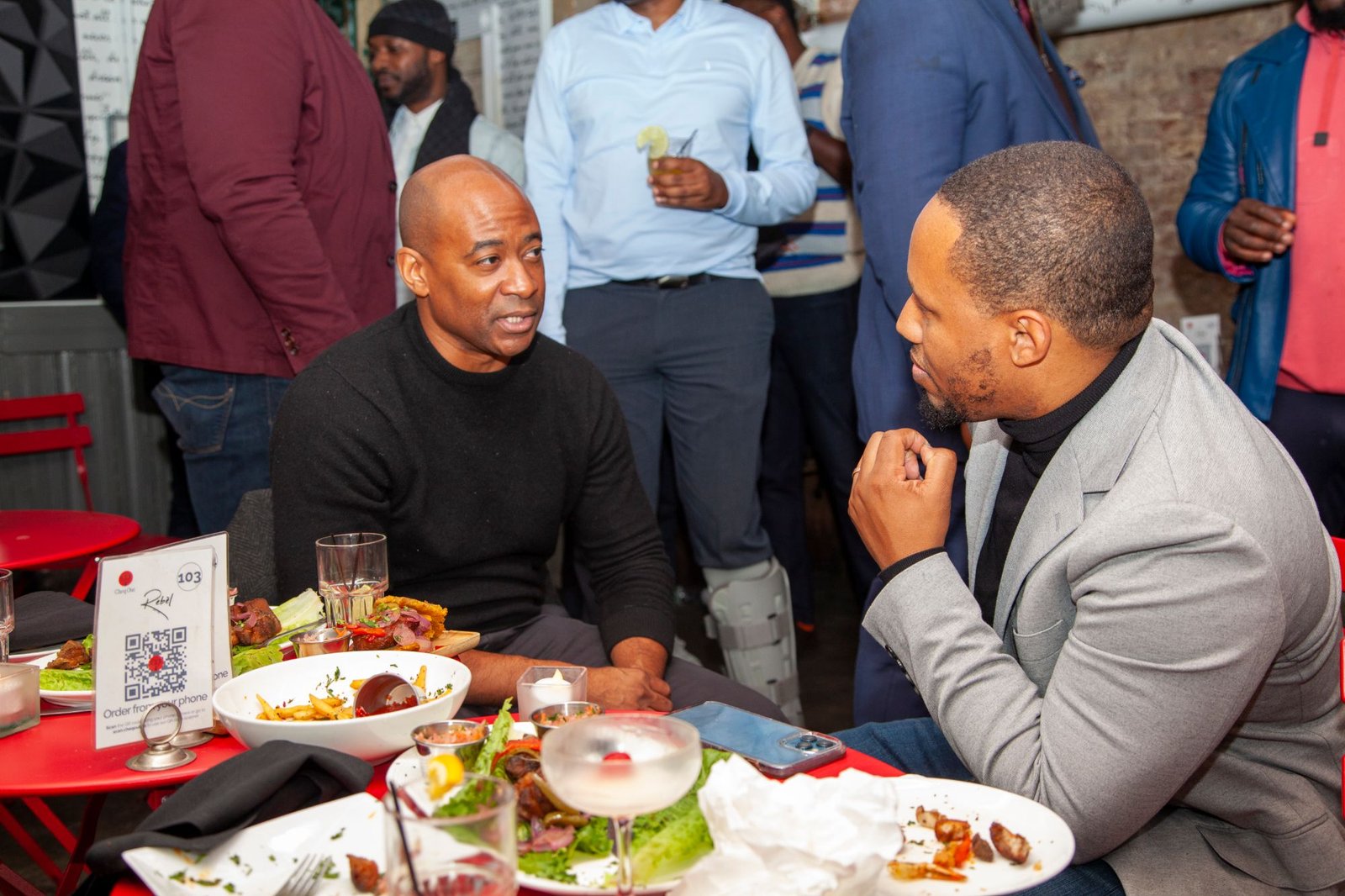 Two Gentlemen's Factory members in conversation at a signature event