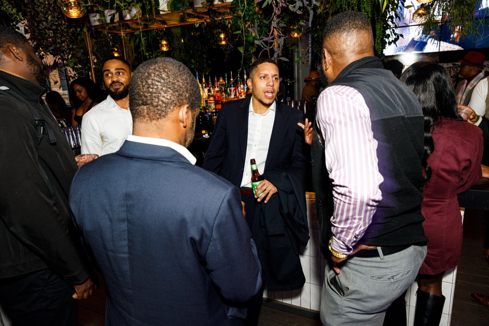 Gentlemen's Factory members socializing on a Brooklyn rooftop at a signature event
