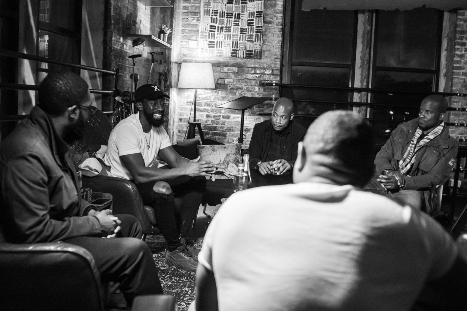 A circle of Gentlemen's Factory members in conversation