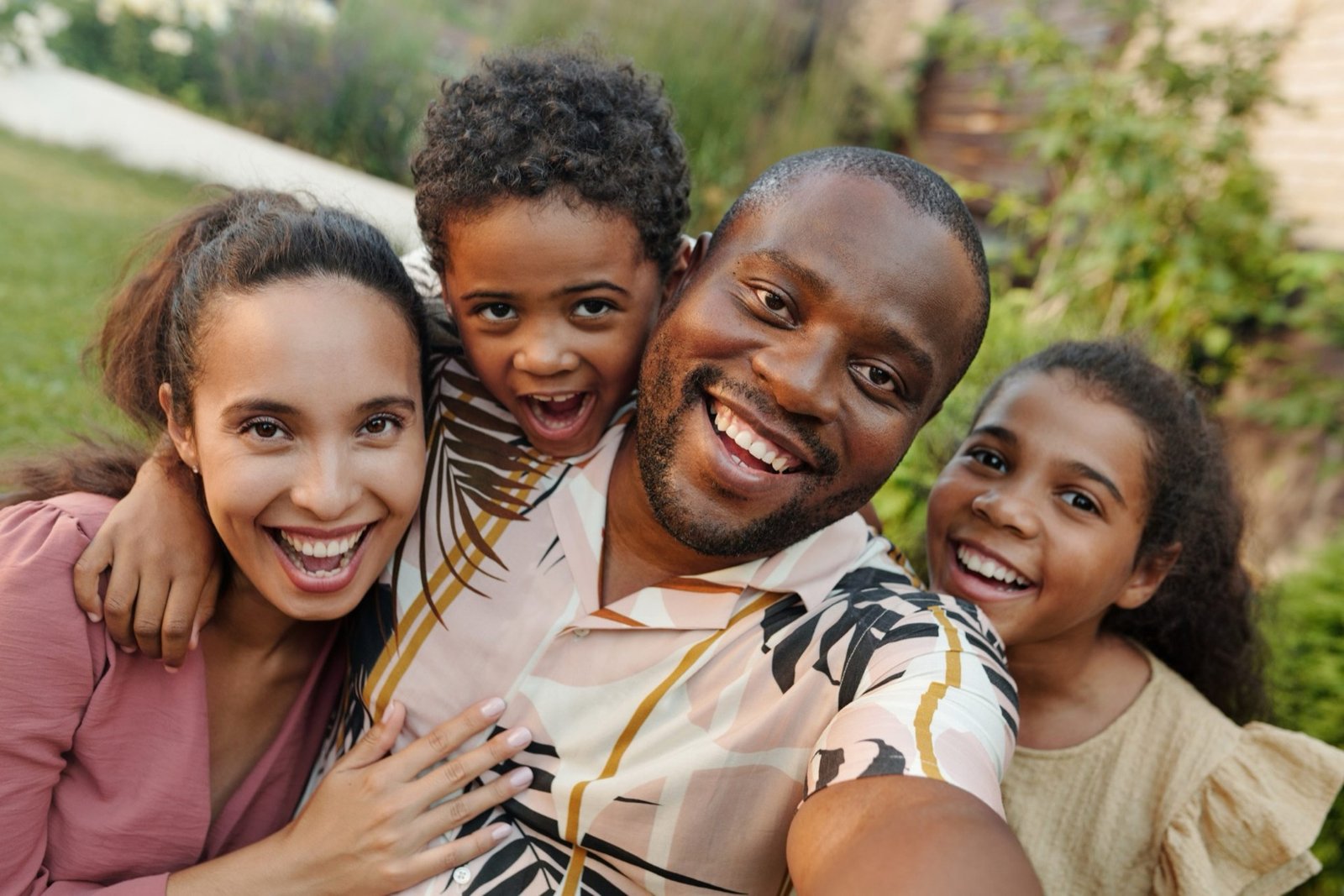 A smiling family embracing together outdoors