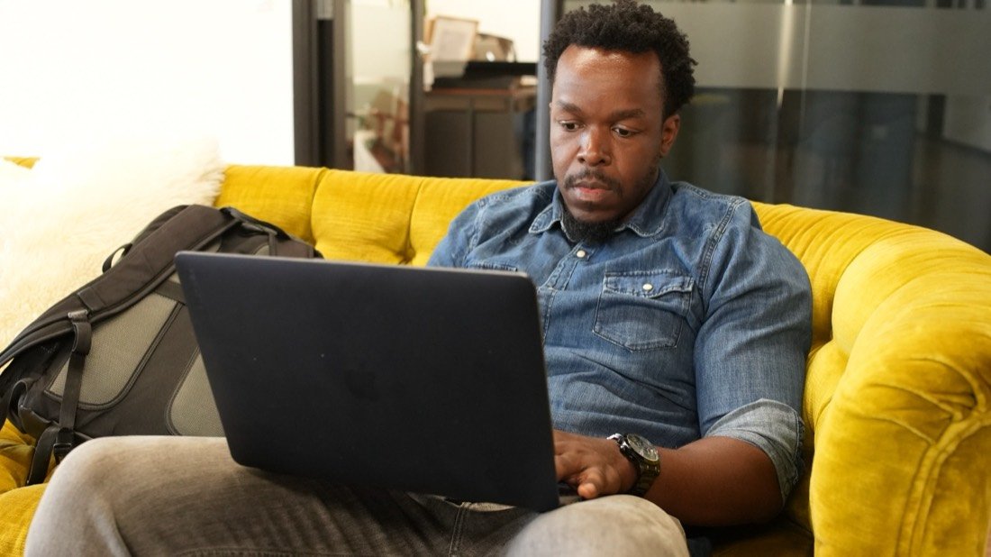 A member working on his laptop in the lounge