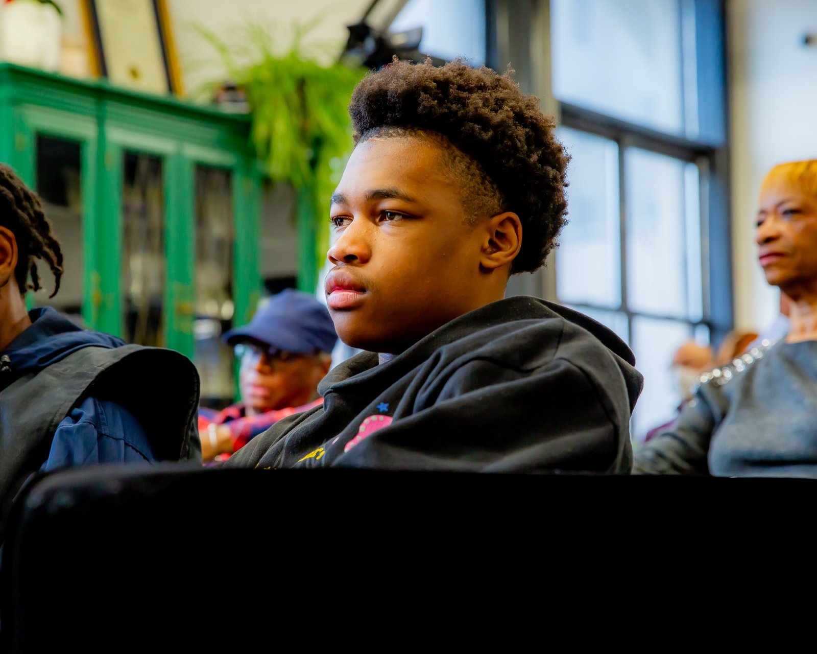 A young man in a Gentlemen's Factory school program reflecting during a session