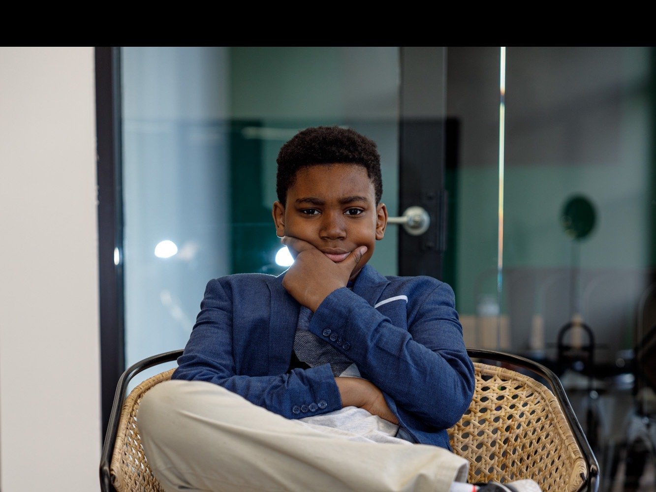 A confident young man in a blazer during a Gentlemen's Factory school program session
